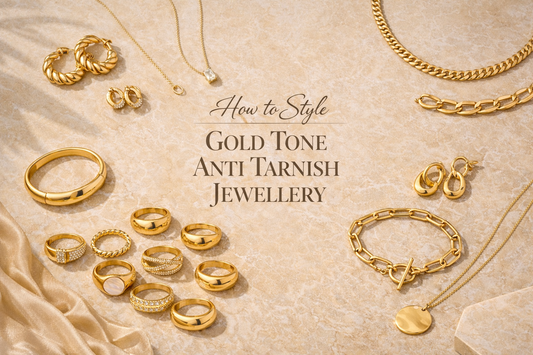 Landscape flat lay of gold tone anti tarnish jewellery collection styling guide with rings necklaces bracelets and earrings