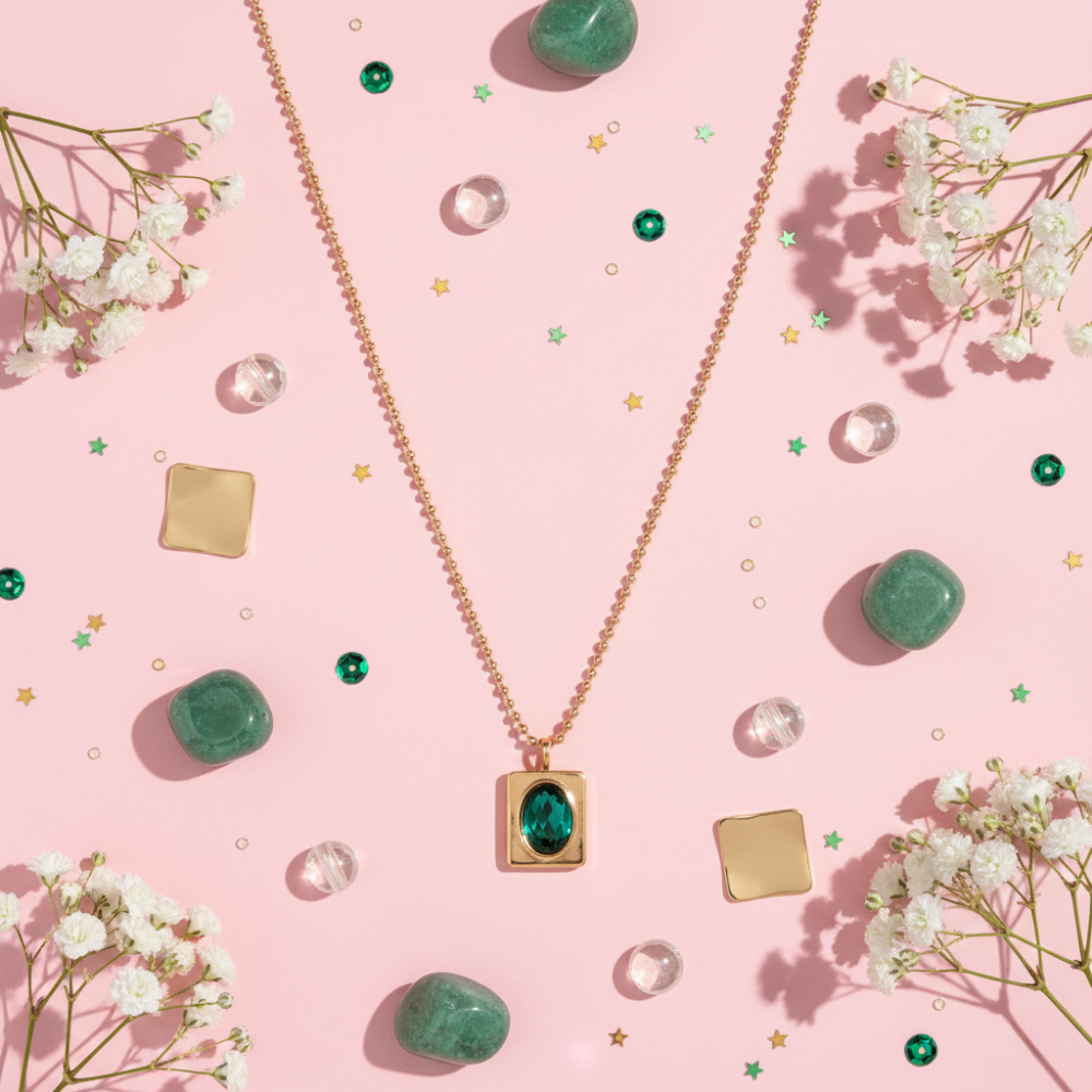 Necklace with a green pendant on a pink background
