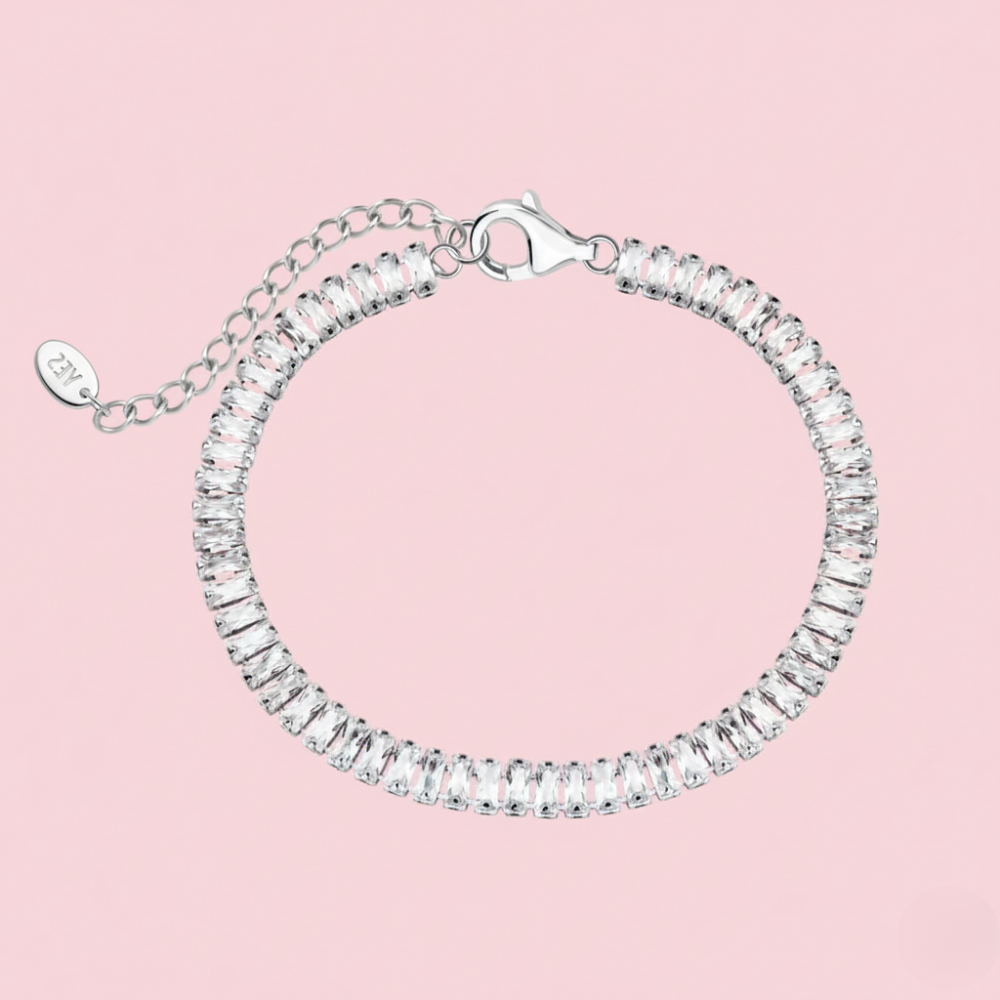 Silver bracelet with clear stones on a pink background