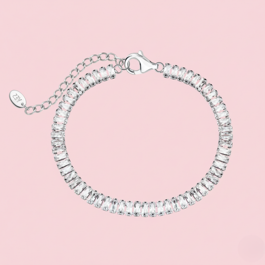 Silver bracelet with clear stones on a pink background